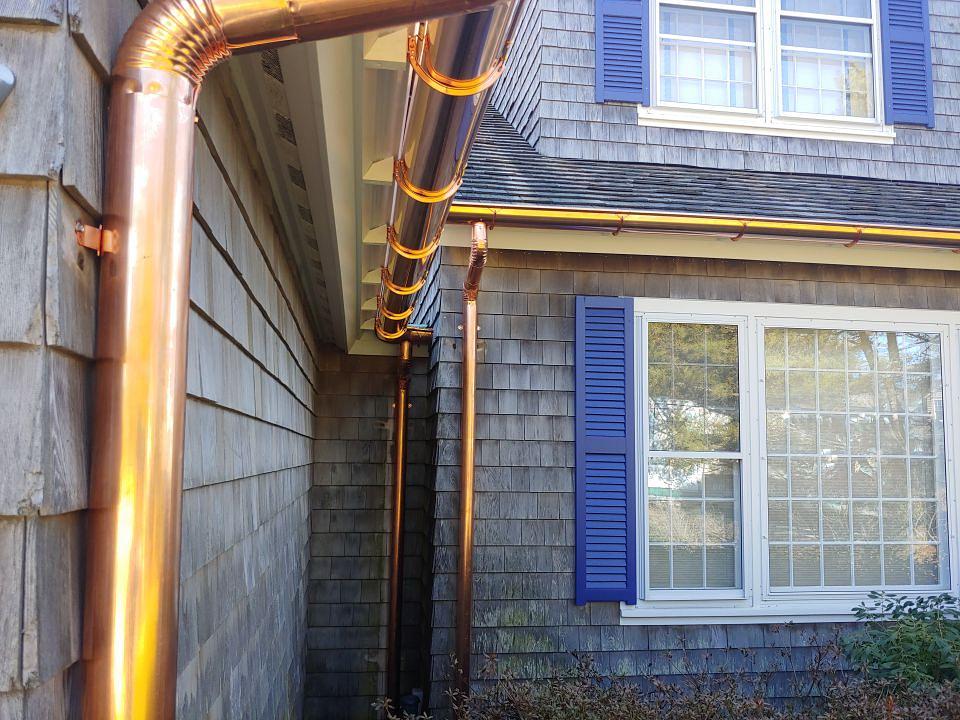 Elegant Copper Gutters Installed on Shingle-Style Home with Blue Shutters