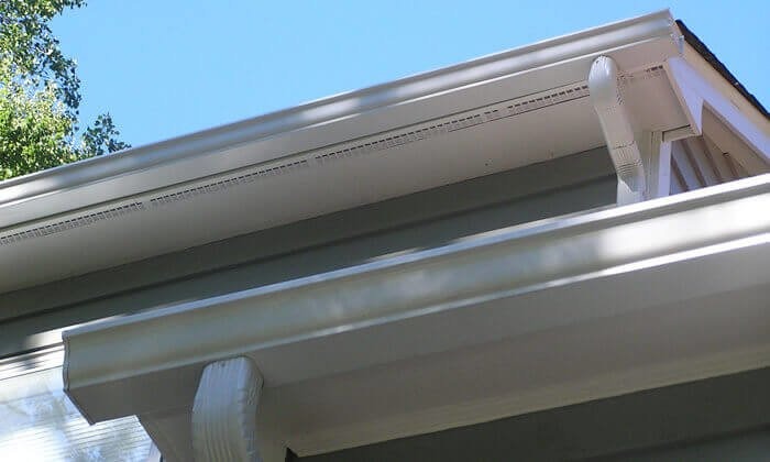 Well-Maintained White Gutters with Downspouts on a Modern Home