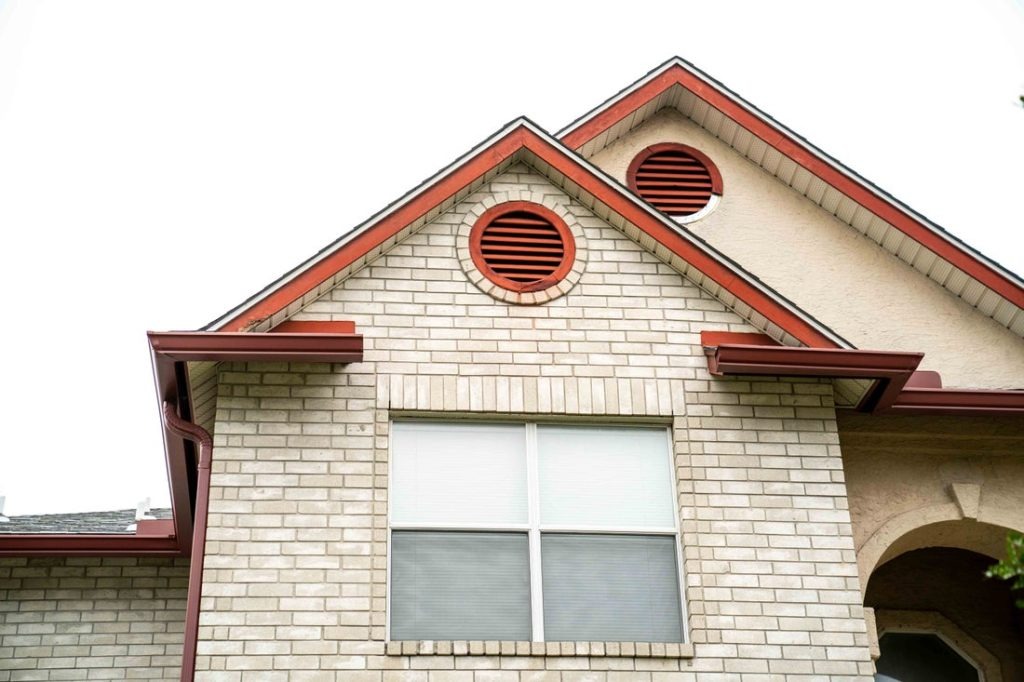 Modern Home Exterior with Red Gutters and White Brick Walls