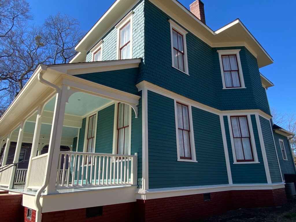 White Gutters Enhancing a Historic Home's Roofline and Porch Design