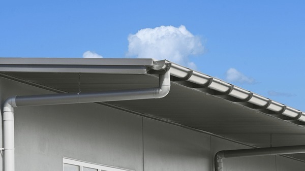 Sturdy Metal Gutters and Downspouts on a Modern Building Exterior